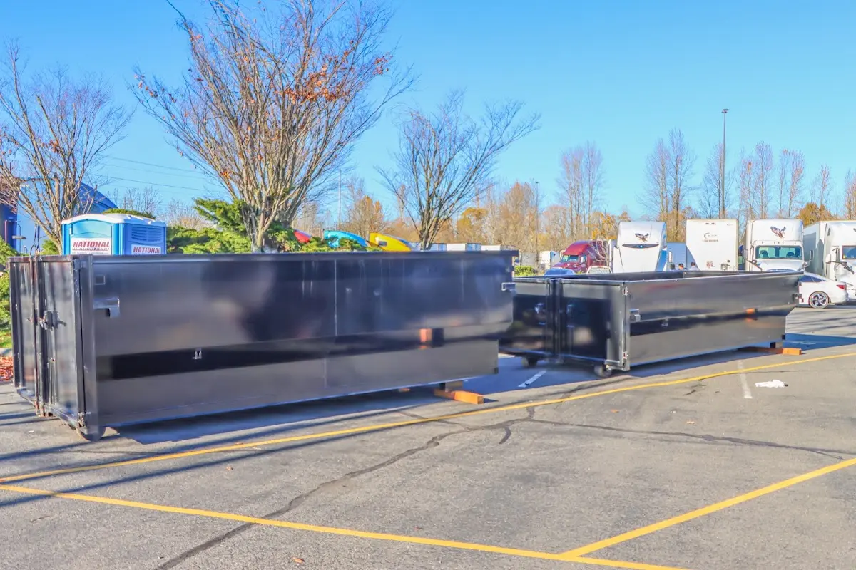 Professional dumpster rental service with roll-off container on residential driveway in Elizabeth